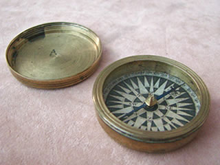 Antique brass cased pocket compass with screw on lid